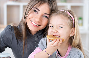 mom and daughter eating a bagel